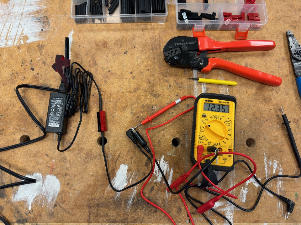 Using a multimeter to tests a KSC-25LS power supply with Powerpole spliced into the DC input